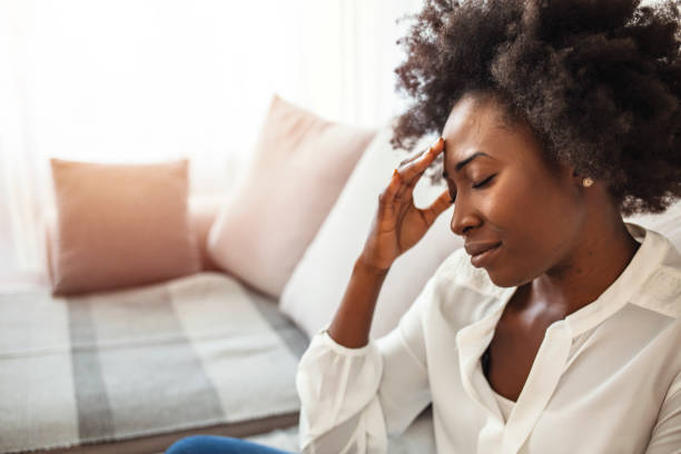 istock African woman sitting on couch feels unhappy having problems. 1275798755