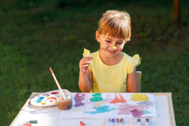 istock A smiling little girl with her artwork 1275798848