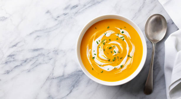 istock Pumpkin soup with cream. Marble background. Copy space. Top view. 1275800037