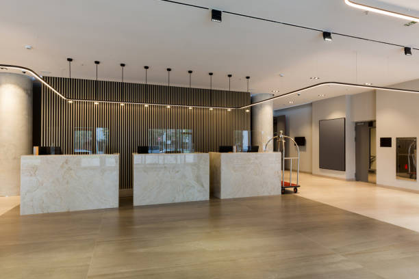 istock Interior of a hotel lobby with reception desks with transparent coronavirus guards 1275800393