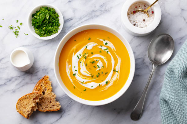 istock Pumpkin traditional soup with creamy silky texture. Marble background. Top view. 1275801629
