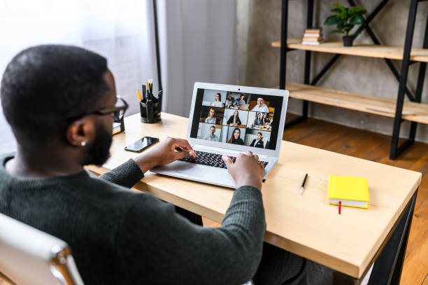 istock A guy talking online with employees via video call 1275801861