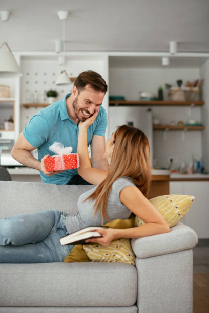 istock Husband surprising his wife with a gift. 1275801908