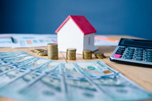 istock money and house model with calculator 1275803195