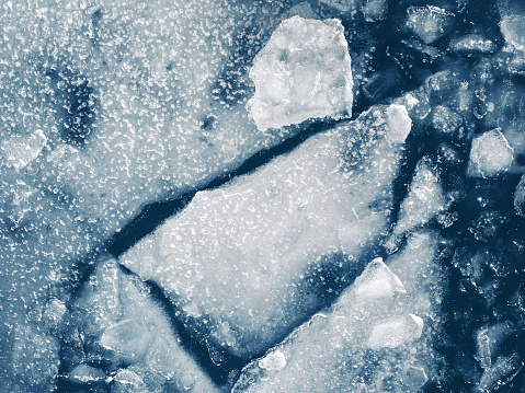 The natural chopped ice crystals. Shiny frozen abstract pattern for background or backdrop. View from above.