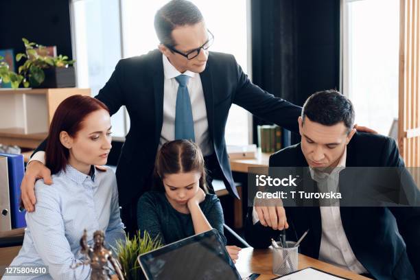 Upset Family Sitting At Table At Lawyer Reception Stock Photo - Download Image Now - Lawyer, Family, Child