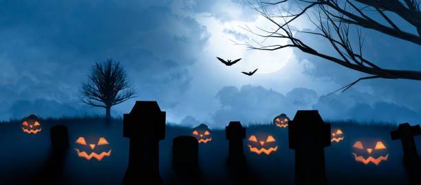 istock spooky halloween pumpkins grinning on a cemetery 1275807542