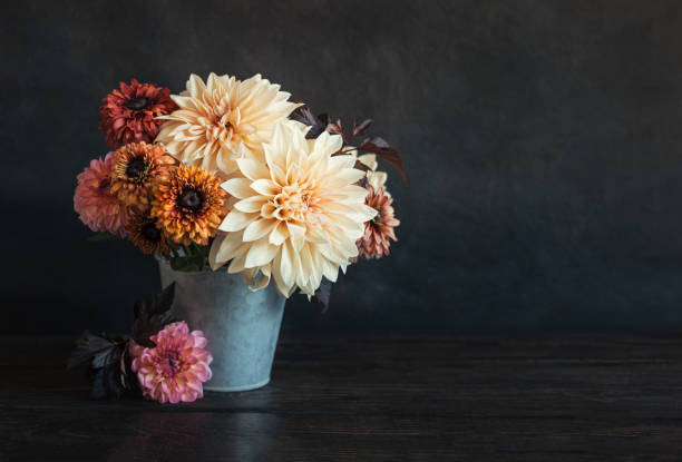 istock Beautiful autumn bouquet  with dahlia flowers on a dark rustic background. 1275808621