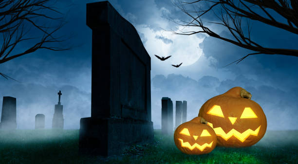 istock spooky halloween background with grinning pumpkins on a cemetery 1275809225