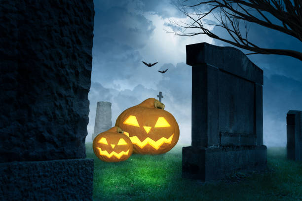 istock creepy halloween background with grinning pumpkins on a cemetery 1275809237