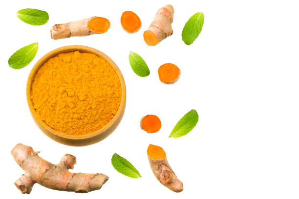 istock Turmeric powder with turmeric root isolated on white background. Top view. 1275810651