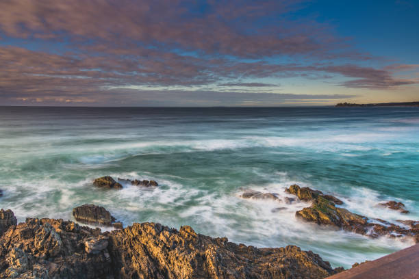 istock Early morning seasape with light cloud and rocks 1275810852
