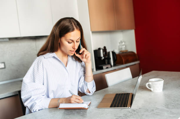 istock Young woman works from home with a laptop 1275811112
