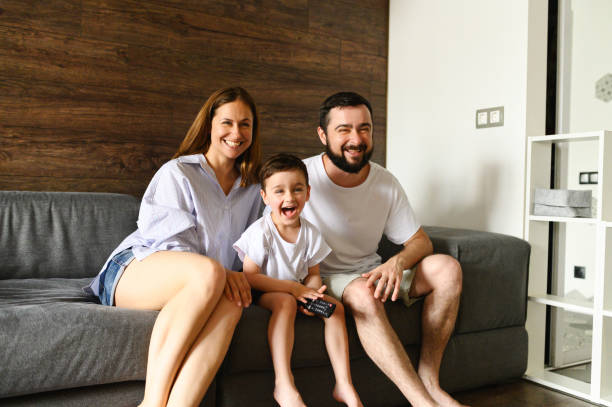 istock Father, mother and little son watching TV 1275811375