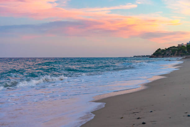 istock Beautiful sunset on a sandy beach with blue water 1275815622