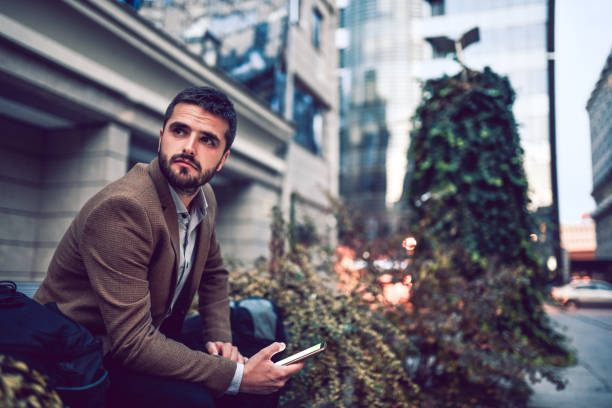 elegant male waiting for his date outside - color image bus discussion expertise imagens e fotografias de stock