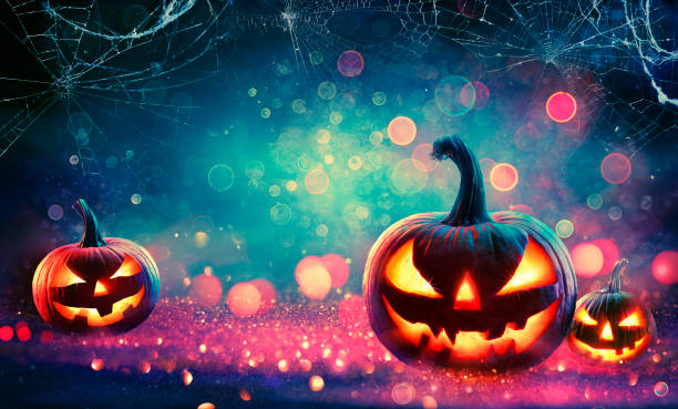 istock Halloween Abstract Party - Smiling Pumpkins On Defocused Shiny Background 1275815908