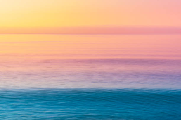 istock Cotton candy sky and blue calm sea. 1275817113