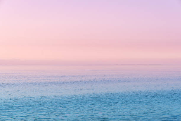 istock Cotton candy sky and blue calm sea. 1275817114
