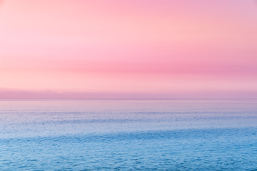 Pastel colored sunset over sea.