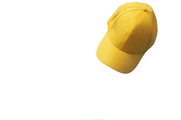 Photo of Yellow baseball cap isolated on white background. Mock up and copy space. Summer time.