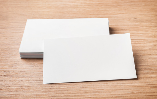 Blank business cards on wooden background.