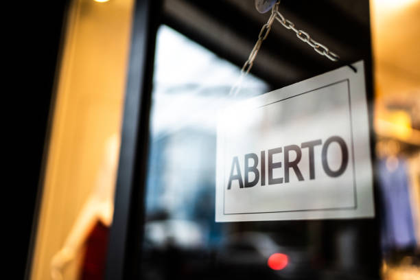 istock Opened sign (abierto) seen through glass door at store 1275821866