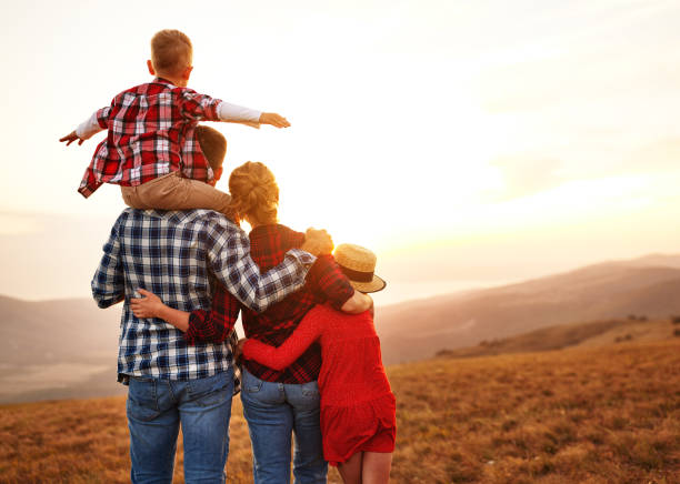 istock Happy family: mother, father, children son and daughter  backs a 1275821914