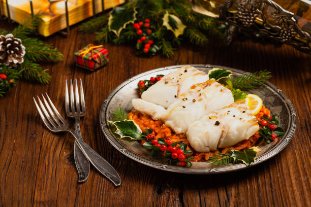 istock Christmas fish. Roasted cod pieces, served in vegetable sauce. 1275822365