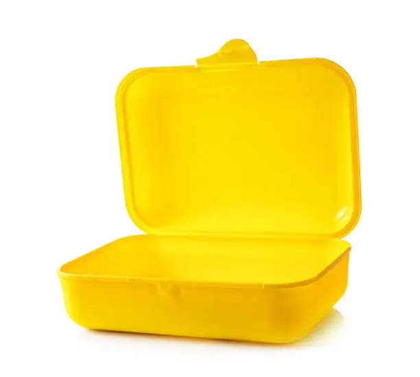 Empty yellow plastic lunch container isolated on white background.