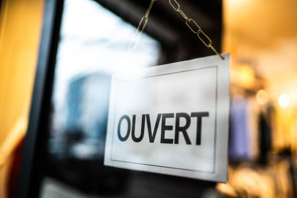 istock Opened sign (ouvert) seen through glass door at store 1275822599