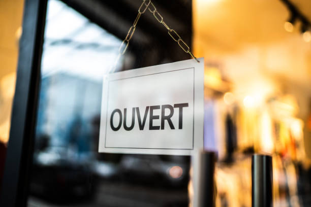 istock Opened sign (ouvert) seen through glass door at store 1275822603