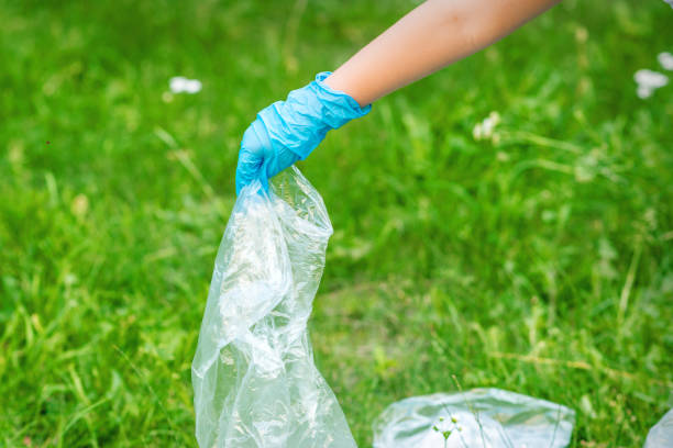 istock Hand of child cleans the park from plastic debris 1275822738