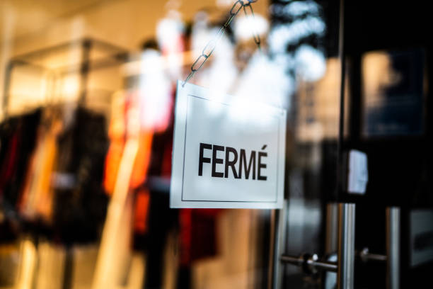 istock Closed sign (fermé) seen through glass by at store 1275822766