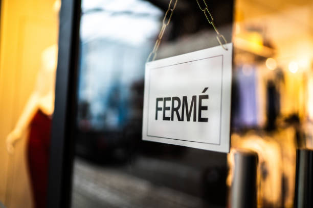 istock Closed sign (fermé) seen through glass by at store 1275822780