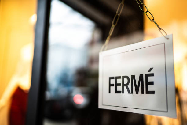 istock Closed sign (fermé) seen through glass by at store 1275822791