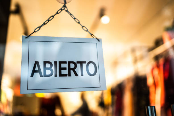 istock Opened sign (abierto) seen through glass door at store 1275823448