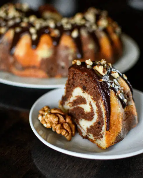 chocolate-cream cake "marble".  poured with chocolate glaze and sprinkled with walnuts