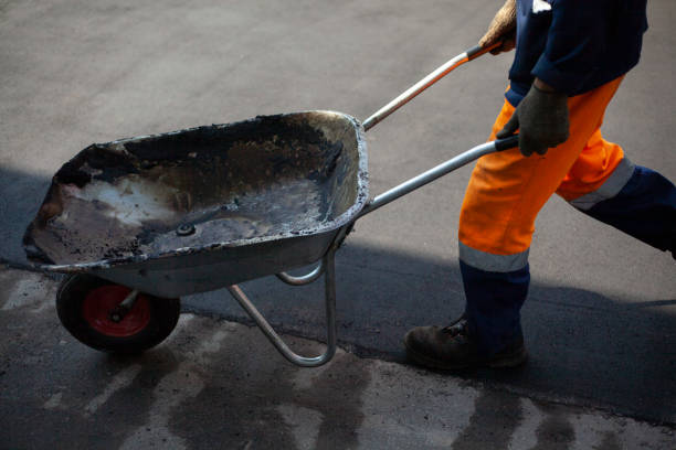 istock Asphalt laying. A worker repairs the road. 1275826216