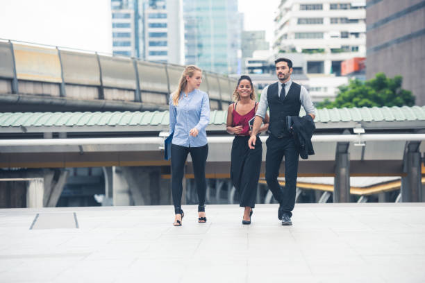 istock Group of business people walking talking. 1275831873