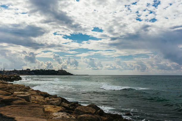Empty Mediterranean beach before the rain near old Yaffa in Tel Aviv, Israel.   Beautiful cloudy sky.