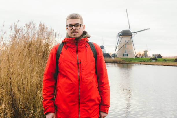 istock Young man tourist exploring the windmills in Kinderdijk in Netherlands 1275832677