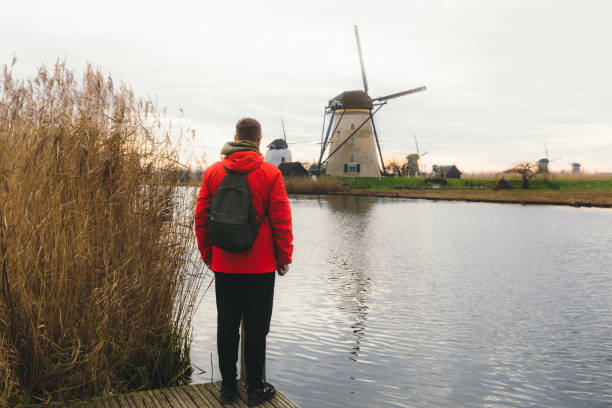 istock Young man tourist exploring the windmills in Kinderdijk in Netherlands 1275833244