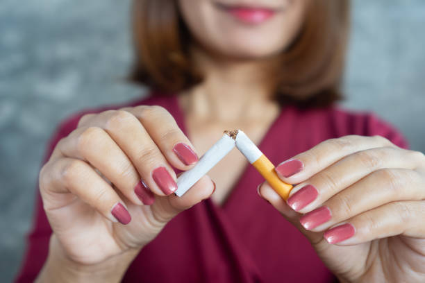 closeup woman hand breaking cigarette stop smoking concept closeup woman hand breaking cigarette stop smoking concept avoidance stock pictures, royalty-free photos & images