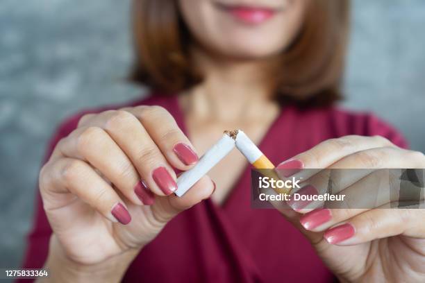 Closeup Woman Hand Breaking Cigarette Stop Smoking Concept Stock Photo - Download Image Now