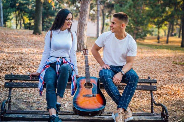 istock Beautiful young couple in park 1275834001