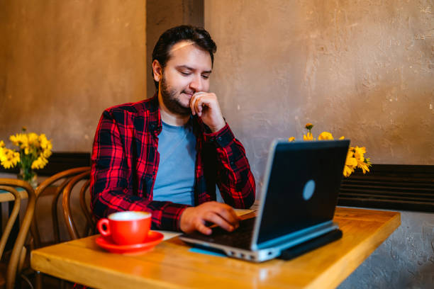 istock Man working online at a cafe 1275837483