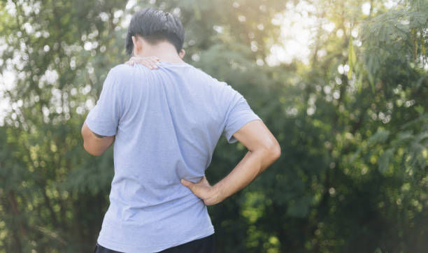 istock Young man suffering from back pain outdoor 1275837758