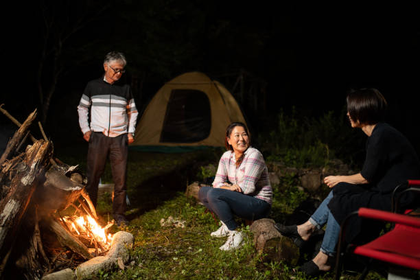 a family enjoying camping - camping tent offspring 60s imagens e fotografias de stock