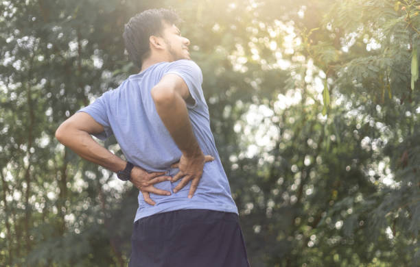istock Young man suffering from back pain outdoor 1275838056